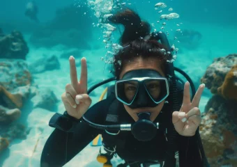 A diver demonstrating buoyancy control while diving in crystal-clear waters.